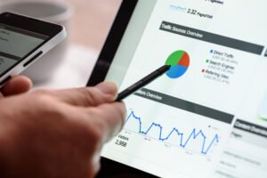 Hand pointing to website analytics data on a tablet screen