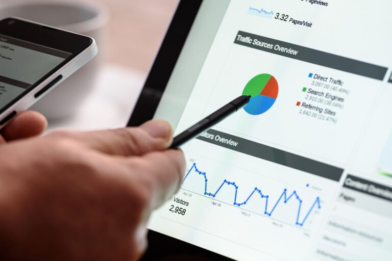 Hand pointing to website analytics data on a tablet screen