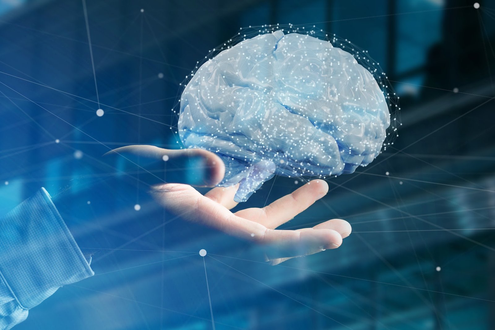 A digital brain floats above an open human hand, symbolizing collaboration between humans and artificial intelligence.