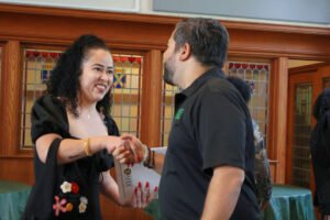 Two small business professionals shake hands at a Pennsylvania outreach event, illustrating the value of in-person business events for making connections.
