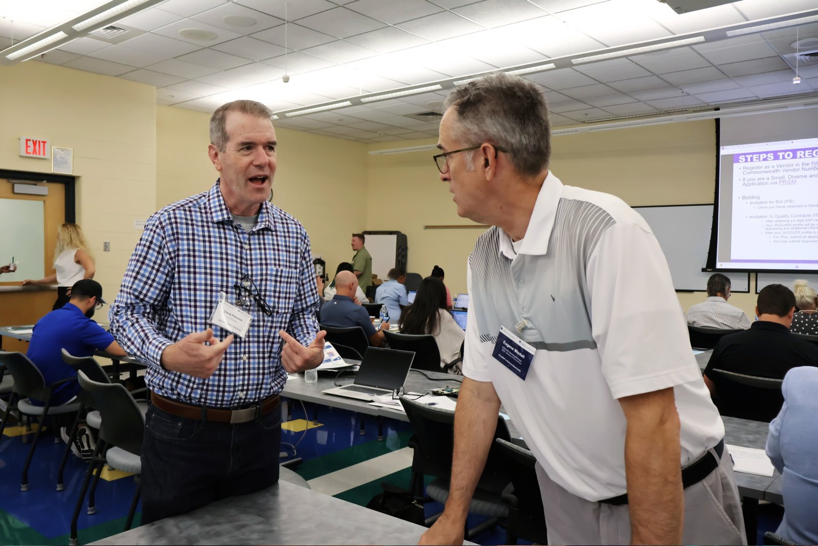 Steve Fillmore of East Falls Media speaks with a PennDOT outreach representative during a small business event in Harrisburg, Pennsylvania. (July 2025)