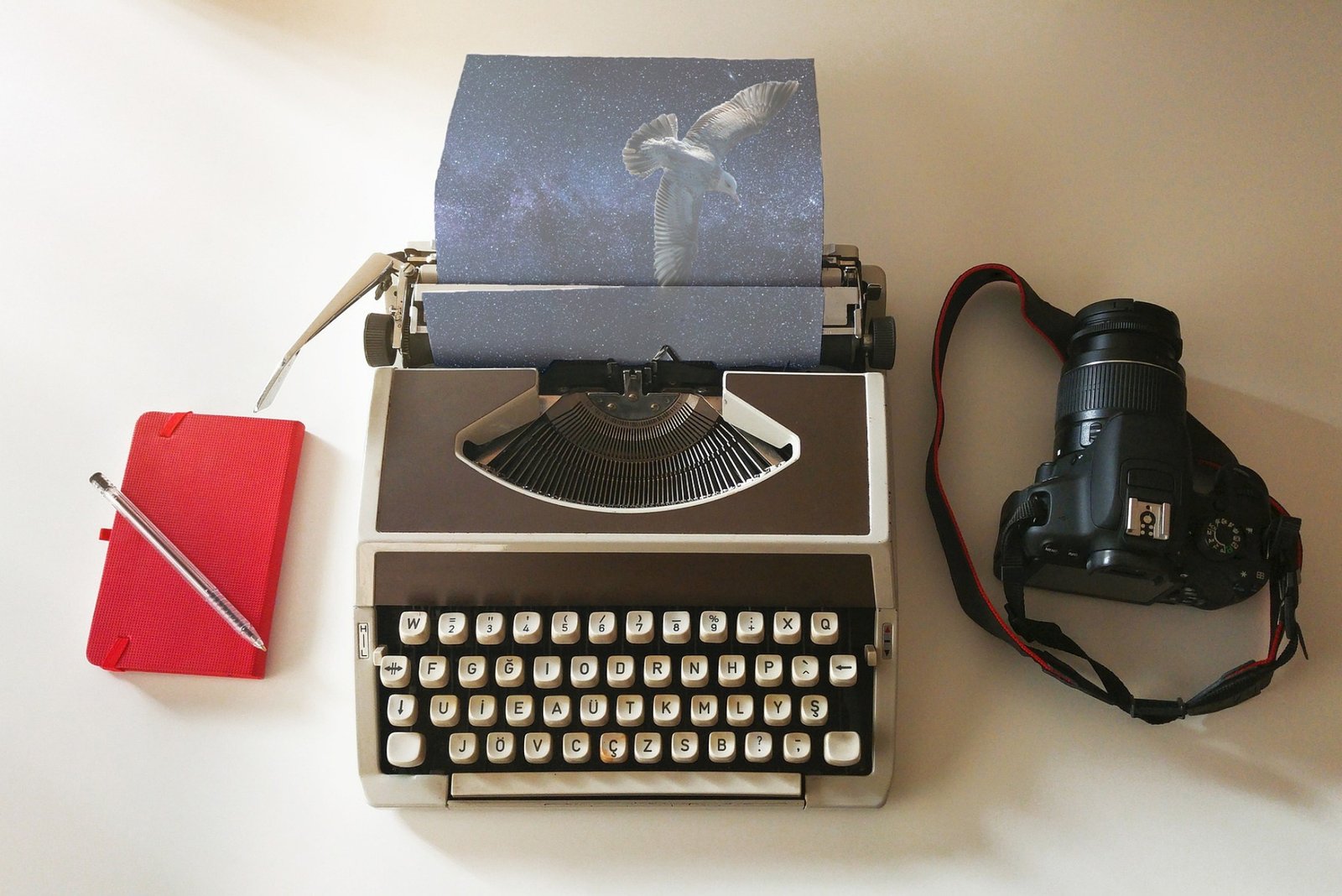 Typewriter, notebook, pen, and camera representing local storytelling for nonprofits