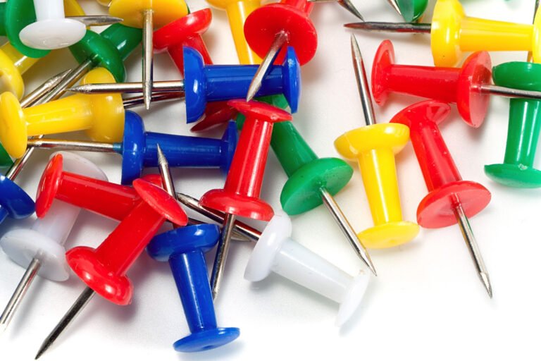 Close-up of colorful pushpins on a white background, symbolizing value mapping for community outreach.