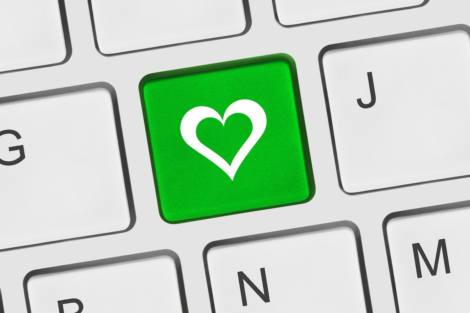 Green keyboard key with a heart icon, symbolizing thoughtful communication and value mapping for community outreach.
