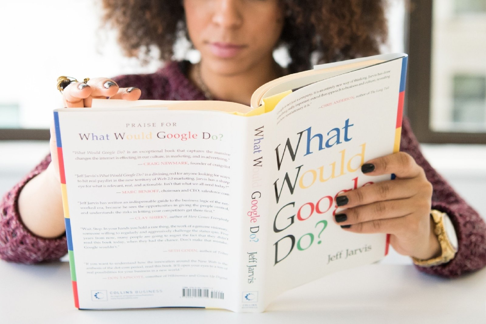 Woman reading What Would Google Do? by Jeff Jarvis